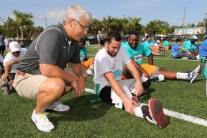 Miami Dolphins General Manager Dennis Hickey interacting with Special Olympics athletes